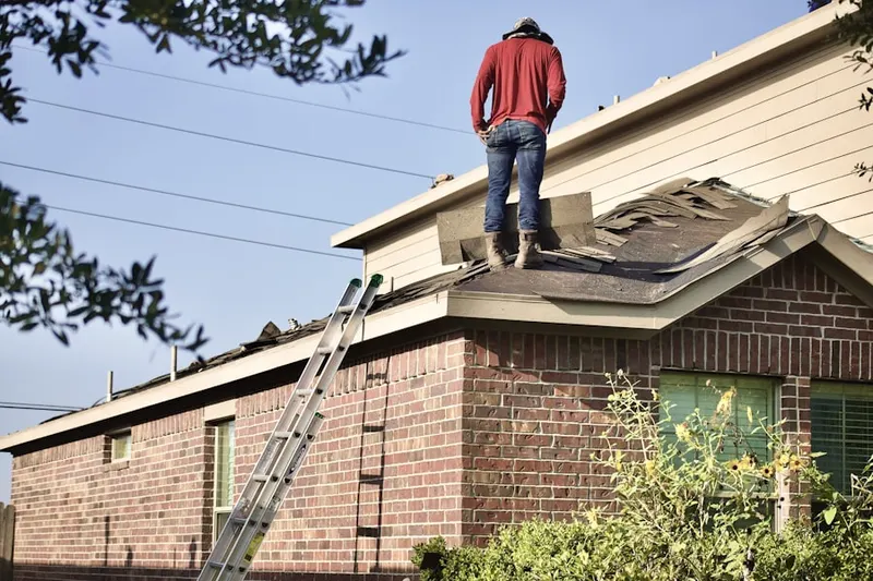 Professional roofer working on a residential roof in Haverford